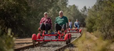 An elderly couple enjoy a railbike ride along the rails at the Rail Explorers: Amador Division