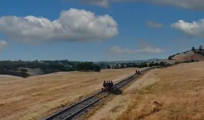 A couple pedals through the countryside at the Amador Division, with bright blue skies overhead.