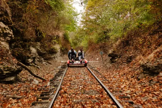 A mom and son journey over gentle bridges through open farmland.