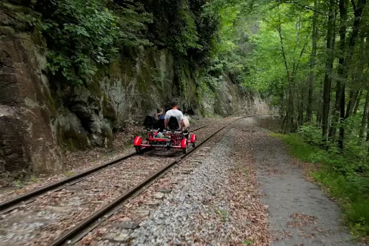 A group of 3 waving at the camera with the spectacular waterfall in the background.