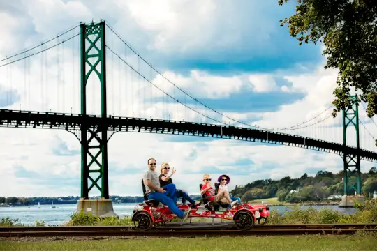 A railbike crosses into the Audubon Society Nature Preserve, as the Narragansett Bay flows underneath.